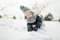 Adorable toddler boy having fun in a backyard on snowy winter day. Cute child wearing warm clothes playing in a snow Royalty Free Stock Photo