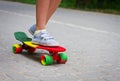 Adorable toddler boy having fun with colorful skateboard outdoors in the park Royalty Free Stock Photo