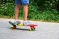 Adorable toddler boy having fun with colorful skateboard outdoors in the park Royalty Free Stock Photo