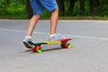 Adorable toddler boy having fun with colorful skateboard outdoors in the park Royalty Free Stock Photo