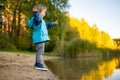 Adorable toddler boy having fun by the Gela lake on sunny fall day. Child exploring nature on autumn day in Vilnius, Lithuania Royalty Free Stock Photo