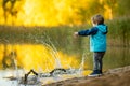 Adorable toddler boy having fun by the Gela lake on sunny fall day. Child exploring nature on autumn day in Vilnius, Lithuania Royalty Free Stock Photo