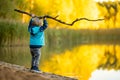 Adorable toddler boy having fun by the Gela lake on sunny fall day. Child exploring nature on autumn day in Vilnius, Lithuania Royalty Free Stock Photo