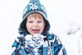 Adorable toddler boy having fun with snow on winter day Royalty Free Stock Photo