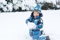 Adorable toddler boy having fun with snow on winter day Royalty Free Stock Photo