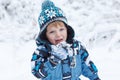 Adorable toddler boy having fun with snow on winter day Royalty Free Stock Photo