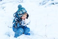 Adorable toddler boy having fun with snow on winter day Royalty Free Stock Photo