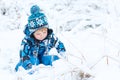 Adorable toddler boy having fun with snow on winter day Royalty Free Stock Photo