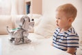 Adorable toddler boy playing with interactive toy. Child with toy robot dog. indoors. Activities for small children. Communication Royalty Free Stock Photo