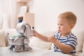 Adorable toddler boy playing with interactive toy. Child with toy robot dog. indoors. Activities for small children. Communication