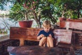Adorable toddler boy sitting on the bench and playing with smartphone. Child learning how to use smartphone. Boy texting on the ph Royalty Free Stock Photo