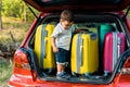 adorable toddler boy standing with travel bags Royalty Free Stock Photo