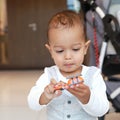 Adorable toddler boy in suit playing with  toy helicopter Royalty Free Stock Photo