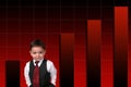 Adorable Toddler Boy In Suit Standing Against Bar Graph