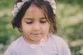 Adorable toddler child girl in light blue dressy outfit walking and playing in blooming spring garden Royalty Free Stock Photo