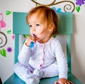 Adorable Toddler Girl Brushes Her Teeth in Pajamas. Health Care concept. Royalty Free Stock Photo