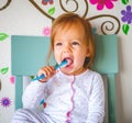 Adorable Toddler Girl Brushes Her Teeth in Pajamas. Health Care concept. Royalty Free Stock Photo