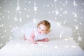 Adorable toddler girl between Christmas lights Royalty Free Stock Photo