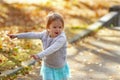 Adorable toddler girl dancing in the park on a beautiful sunny autumn day. Royalty Free Stock Photo