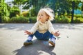 Adorable toddler girl with dirty hands after drawing with colorful chalks Royalty Free Stock Photo