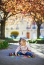 Adorable toddler girl drawing with colorful chalks on asphalt Royalty Free Stock Photo