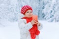 Adorable toddler girl drinking hot chocolate in winter forest. Happy healthy child with cup of steaming cocoa or tea Royalty Free Stock Photo