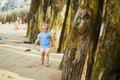 Adorable toddler girl having fun on Sillon beach in Saint-Malo, Brittany, France