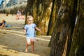 Adorable toddler girl having fun on Sillon beach in Saint-Malo, Brittany, France