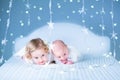 Adorable toddler girl and her newborn baby brother in lights around them Royalty Free Stock Photo