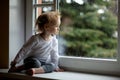 Adorable toddler girl looking though the window Royalty Free Stock Photo