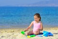 Adorable toddler girl playing with her toys at the beach Royalty Free Stock Photo