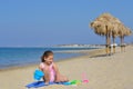Adorable toddler girl playing with her toys at the beach Royalty Free Stock Photo