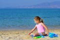 Adorable toddler girl playing with her toys at beach Royalty Free Stock Photo