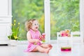 Adorable toddler girl playing maracas in white room Royalty Free Stock Photo