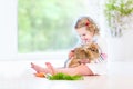 Adorable toddler girl playing with a real bunny Royalty Free Stock Photo