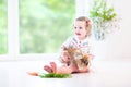 Adorable toddler girl playing with a real bunny Royalty Free Stock Photo