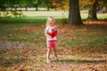 Adorable toddler girl playing soccer in park Royalty Free Stock Photo