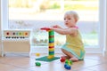 Adorable toddler girl playing with toys on the floor