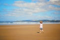 Adorable toddler girl on the sand beach at Atlantic coast