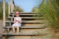 Adorable toddler girl sitting on the stairs Royalty Free Stock Photo