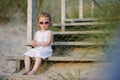 Adorable toddler girl sitting on the stairs Royalty Free Stock Photo