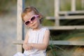 Adorable toddler girl sitting on the stairs Royalty Free Stock Photo