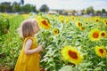 Adorable toddler girl on sunflower field Royalty Free Stock Photo