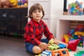 Adorable toddler playing with car toy sitting on floor at home Royalty Free Stock Photo