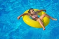 Adorable toddler relaxing in swimming pool