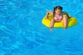 Adorable toddler relaxing in swimming pool