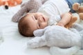 Adorable toddler smiling confident lying on bed with dolls at bedroom Royalty Free Stock Photo