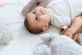 Adorable toddler smiling confident lying on bed with dolls at bedroom Royalty Free Stock Photo