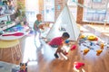 Adorable toddlers playing around lots of toys at kindergarten