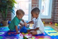 Adorable toddlers playing around lots of toys at kindergarten Royalty Free Stock Photo